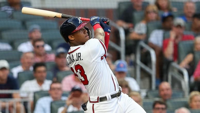 Atlanta Braves outfielder Ronald Acuña Jr. confronted by two fans